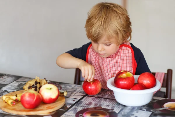 Adorable little boy helping and baking apple pie in home''s kitc — Stock Photo, Image