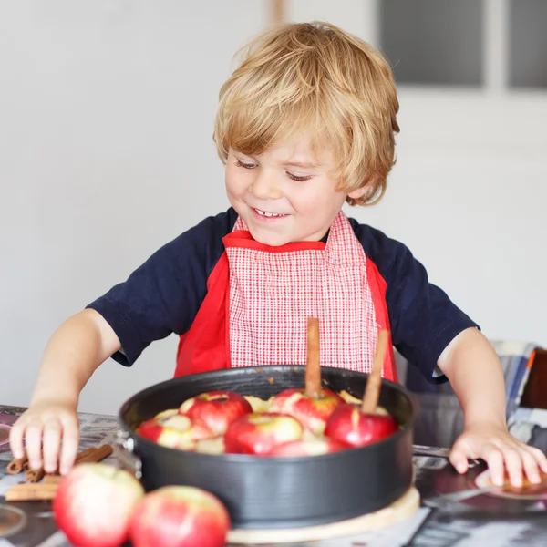 Adorable little boy helping and baking apple pie in home''s kitc — Stock Photo, Image