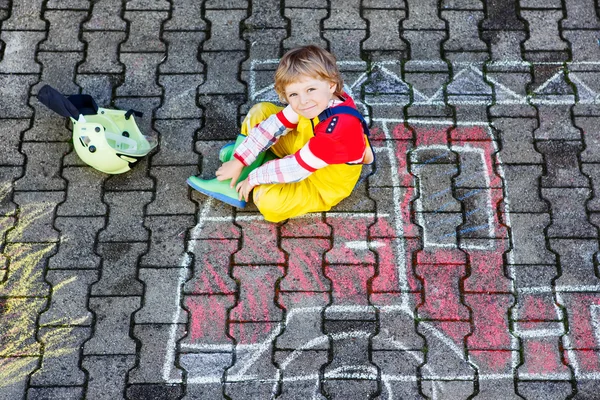 Funny adorable child of four years having fun with fire truck pi — Stock Photo, Image