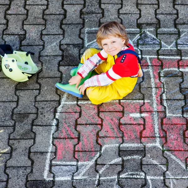 Funny adorable child of four years having fun with fire truck pi — Stock Photo, Image