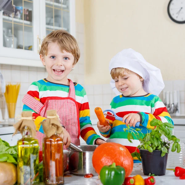 Two cute little children cooking italian soup and meal with fres — Stock Image Two cute little children cooking italian soup and meal with fres Stock Photo