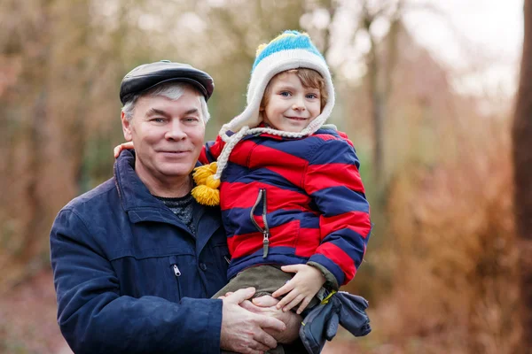 Happy grandfather with his grandchild on arm — Stock Photo, Image