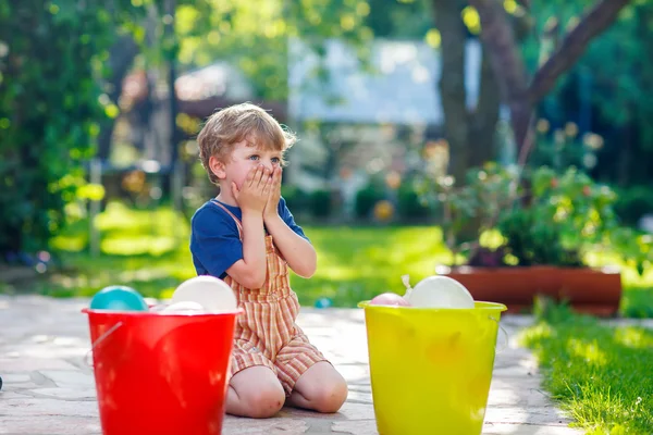 Little toddler boy having fun with splashing water in summer gar — Stock Photo, Image