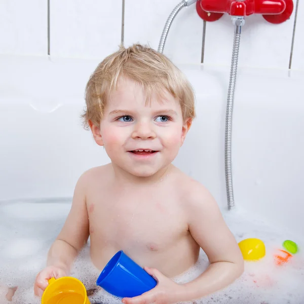 Adorable toddler boy having fun in bathtub Royalty Free Stock Images