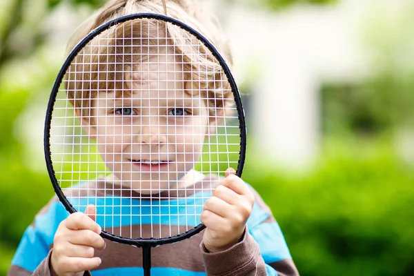 Little cute funny kid boy playing badminton in domestic garden — Stock Photo, Image