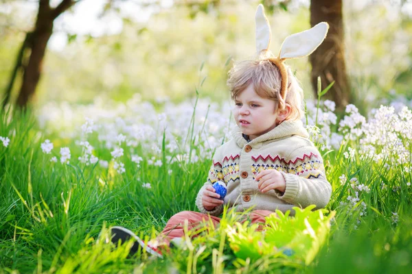 Lindo niño feliz vistiendo orejas de conejo de Pascua en primavera verde —  Fotos de Stock