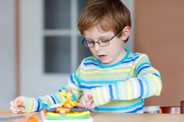 Happy little child, adorable creative kid boy playing with dough — Stock Photo, Image