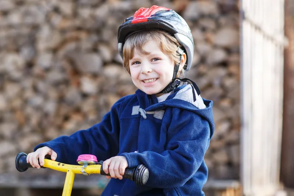 Little boy riding bicycle in village or city — Stock Photo, Image