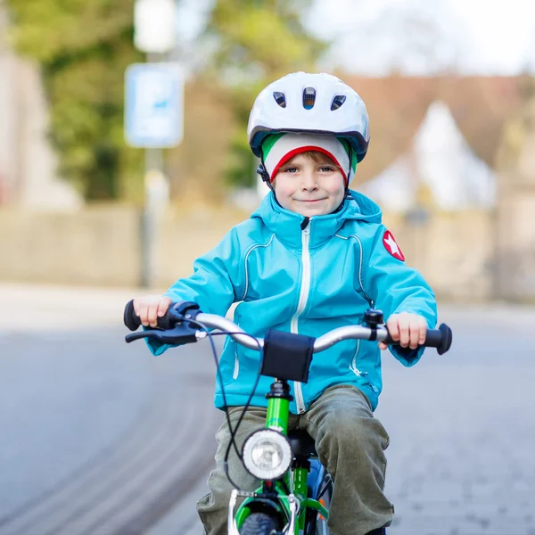 Little preschool kid boy riding with his first green bike — Stock Photo, Image