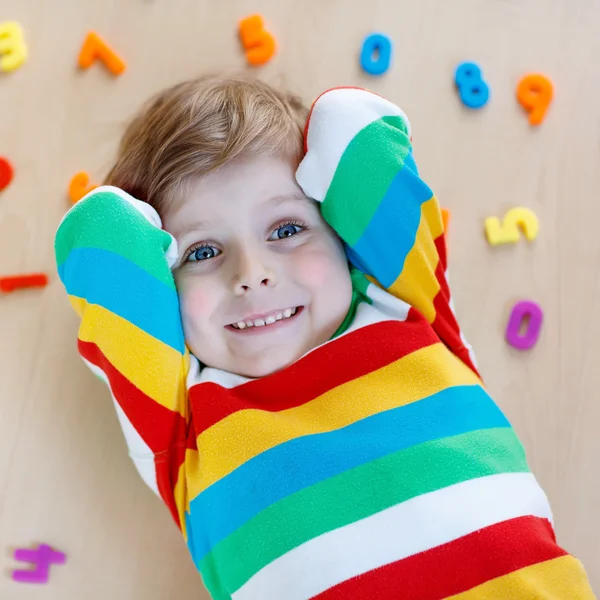 Kid boy with colorful numbers, indoor — Stock Photo, Image
