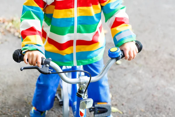 Little child on first bike. Hands of kid. — Stock Photo, Image