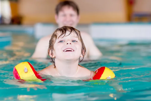 Little kid boy and his father swimming in an indoor pool — Stok fotoğraf