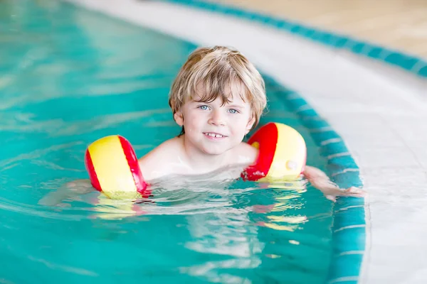 Dítě chlapec s swimmies, učil jsem se plavat v krytý bazén — Stock fotografie