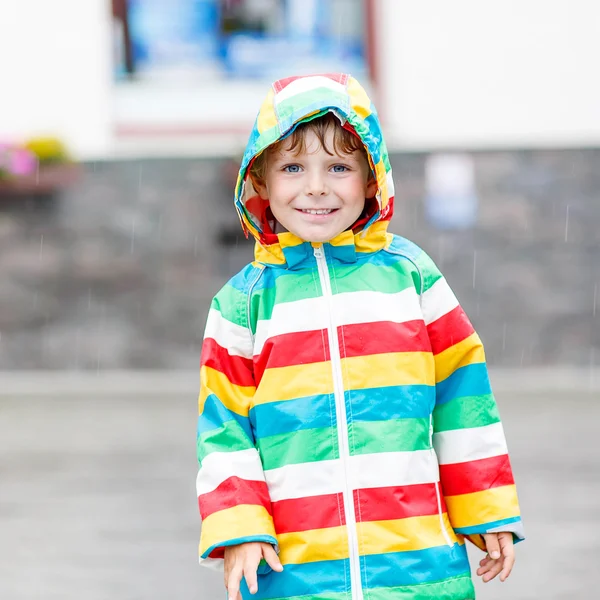 Little blond kid boy walking with big umbrella outdoors — Stock Photo, Image