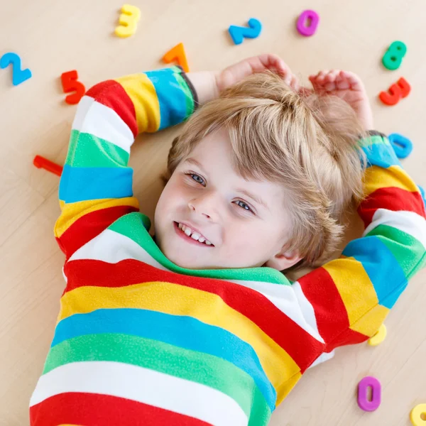 Kid boy with colorful numbers, indoor — Stock Photo, Image