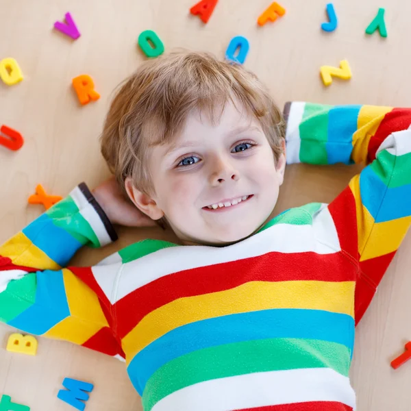 Kid boy with colorful letters, indoor — Stock Photo, Image