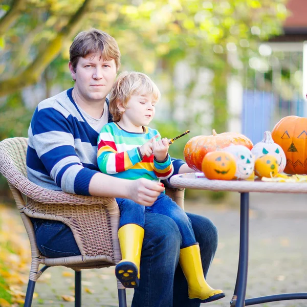 ハロウィーンのため小さな子供と彼の父親は作るジャック-o-ランタン — ストック写真