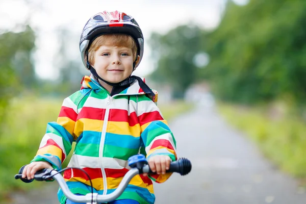 Portrait of funny cute kid with helmet on bicycle — Stock Photo, Image