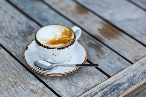 Cup of coffee on a wooden table