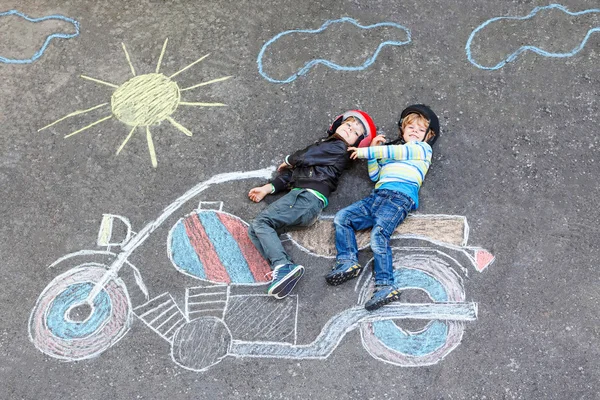 Dos niños niños en casco con dibujo de la foto de la motocicleta con colo —  Fotos de Stock