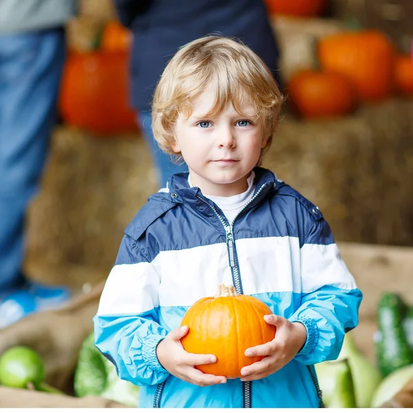 Little blond kid boy holding green pumpkin — Stock Photo, Image