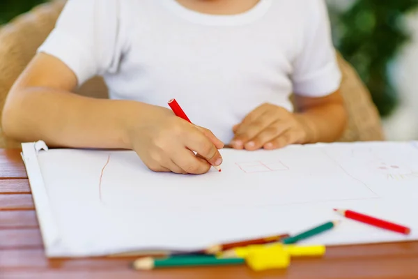 Hands of preschool kid boy making homework — Stock Photo, Image