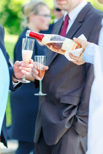 Waiter with bottle of champagne on wedding — Stok fotoğraf