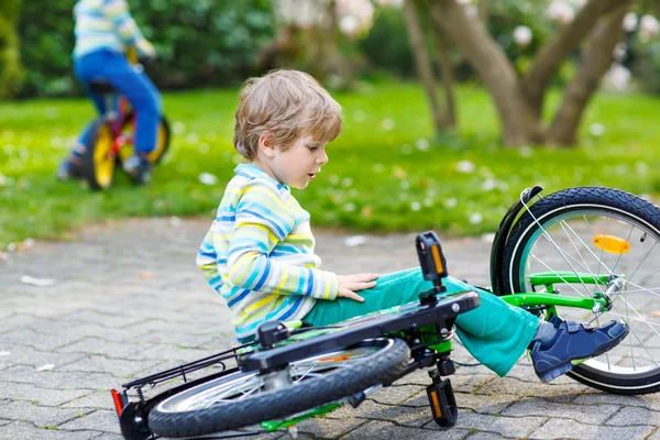 Little kid boy fell down of his first bike Royalty Free Stock Images