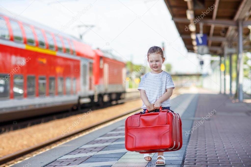 Cute little girl on a railway station.