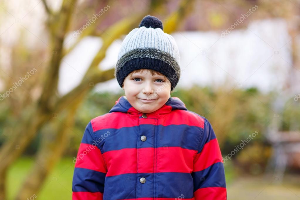 Kid boy in bright colorful clothes outdoors