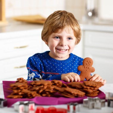 Boy baking Christmas cookies at home