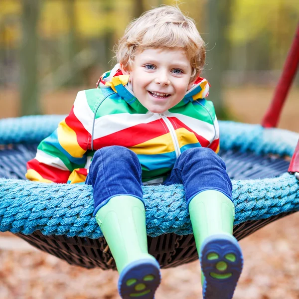 Little kid boy having fun on autumn playground — Stock Photo, Image