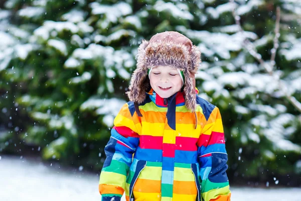 Kleiner Junge spielt im Winter im Freien mit Schnee. — Stockfoto