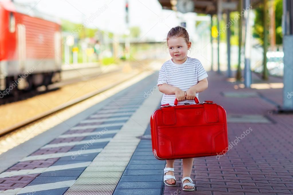 Cute little girl on a railway station.