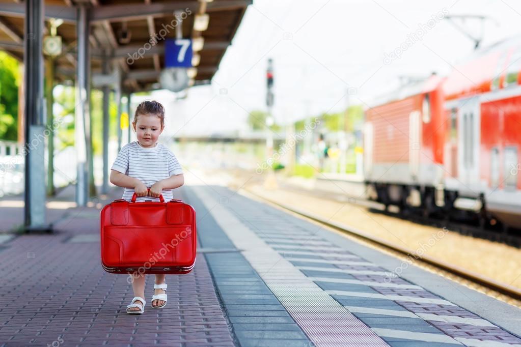 Cute little girl on a railway station.