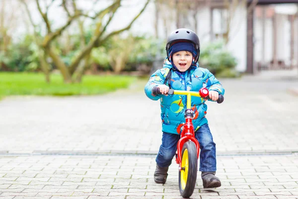 Little boy riding with his first bicycle outdoors — 图库照片