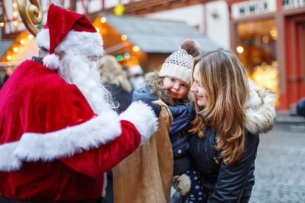 Anneyle Noel piyasasında küçük yürümeye başlayan çocuk kız. — Stok fotoğraf