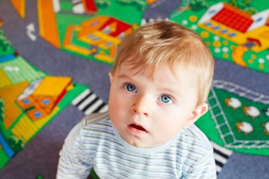 little baby playing with different toys indoors