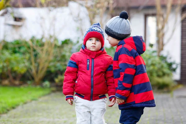 Two little kid boys walking together outdoors. — Stok fotoğraf