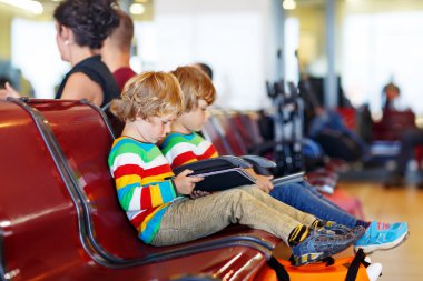 Two tired little sibling boys at the airport