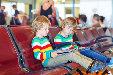 Two tired little sibling boys at the airport