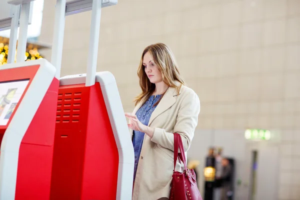 Kvinna på internationella flygplats väntar flyg på terminal — Stockfoto