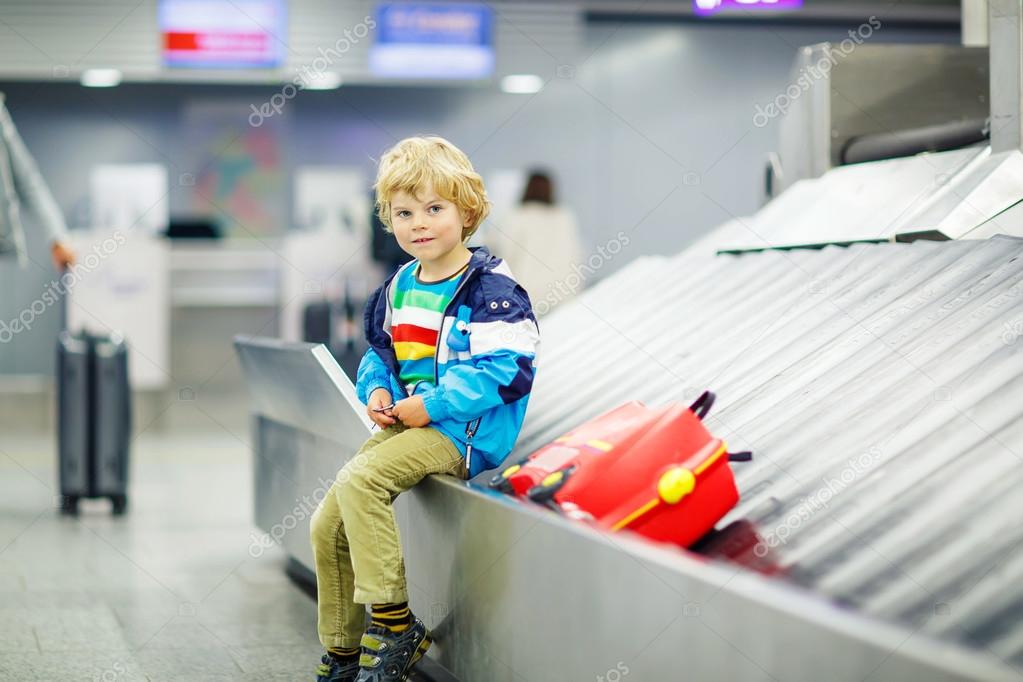 little tired kid boy at the airport, traveling