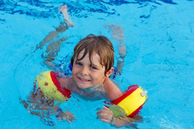 little boy having fun in an swimming pool