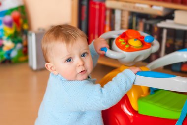 Baby with blue eyes looking at camera, indoors
