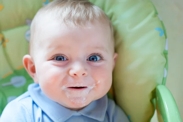 Bebé con ojos azules mirando a la cámara, en el interior — Foto de Stock