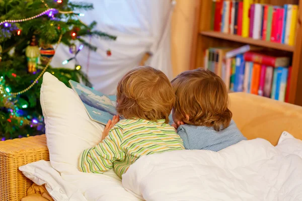 Two little sibling boys reading book on Christmas — Stock Photo, Image