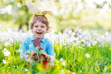 Küçük çocuk yeme çikolata Paskalya bunny açık havada çocuk