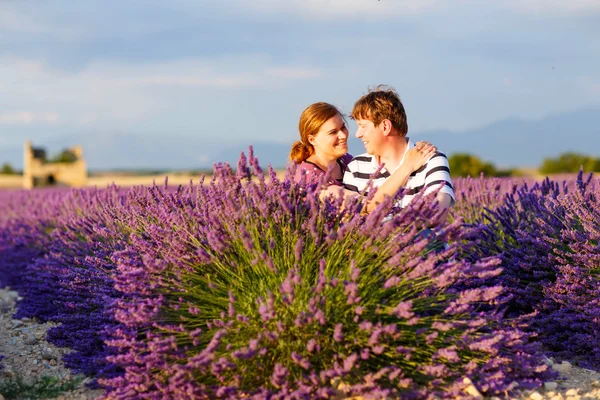 Romantic couple in love in lavender fields in Provence, France