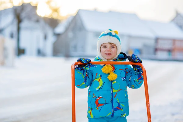 Little kid boy playing with snow in winter, outdoors — Stock Photo, Image